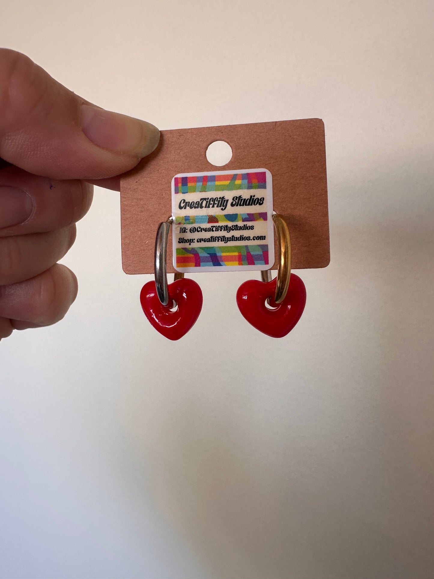 Cooler than Sin: Mixed Metals Huggie hoops with red glass heart charm
